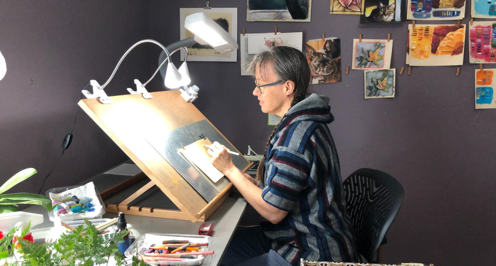 me at my table easel working in my sketchbook